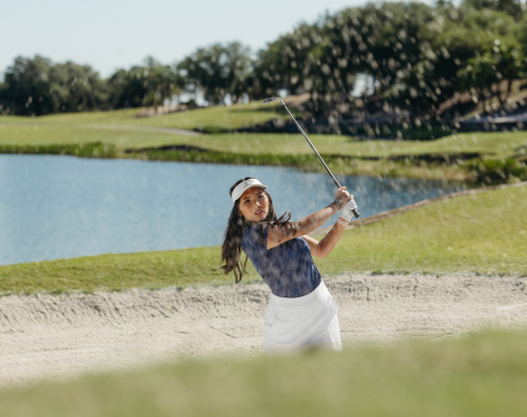 Golfer playing a bunker shot at Reunion